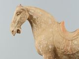 a statue of a horse with a saddle on it ' s back