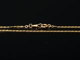 a gold chain bracelet on a black background