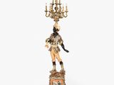 a figurine of a man with a chandelier on top of it