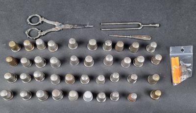 a lot of coins and a pair of scissors on the table
