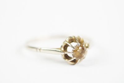 a close up of a ring with a flower on it