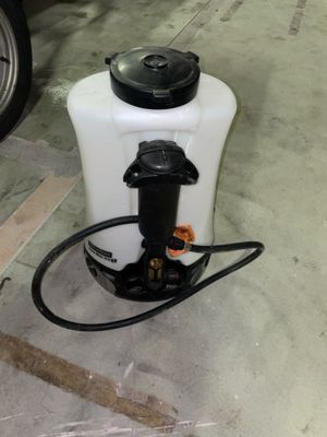 a white container with a black cap and a hose attached to it