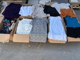 many boxes of clothes that are sitting on the ground