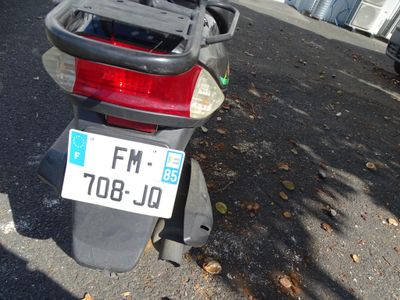 a motor scooter parked on the side of the street