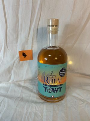 a bottle of rum sitting on a white sheet
