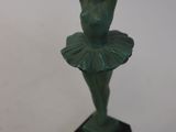 statue of a woman in a tutu on a marble base