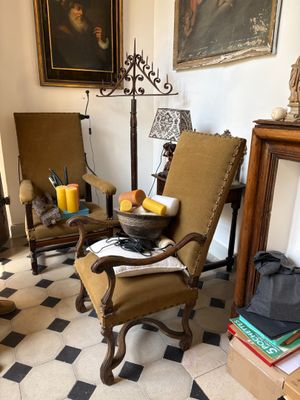 two chairs and a table in a room with a checkered floor