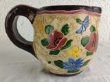 a coffee cup with a floral design on it