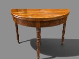 an old wooden table with a curved top and turned legs