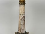 an image of a marble pedestal with a lamp on top