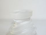 a clear glass jar with a lid on a table