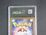 the pokemon card is in a plastic case on a table