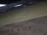 a close up of a car ' s front bumper with bullet holes on it