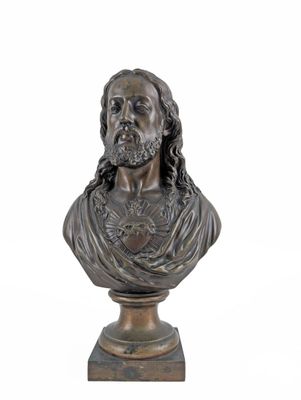 a bronze bust of a man with long hair and beard