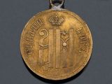 an image of a gold medal with a crown on it