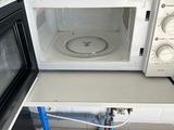 two microwaves sitting on a counter in a kitchen