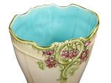 a blue bowl with flowers on it sitting on a table