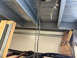 a picture of a garage with a ceiling fan and some tools