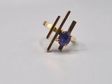 an image of a gold ring with a blue stone on it
