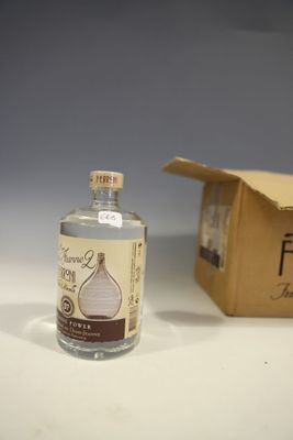 a bottle of alcohol sitting next to a cardboard box