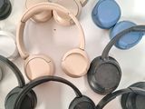 many different colored headphones on a white surface