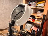 an image of a desk with a lamp and a pile of papers