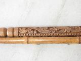 an image of a wooden cane with a carved handle on a table