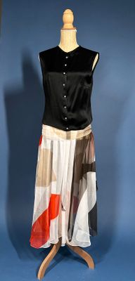 a dress on a mannequin stand on a blue background