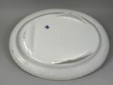 a white plate with a blue flower on it