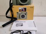 a camera and headphones on a table next to a box