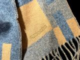 a blue and yellow checkered scarf on a black background