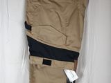 men ' s khaki pants hanging on a hanger on a white curtain