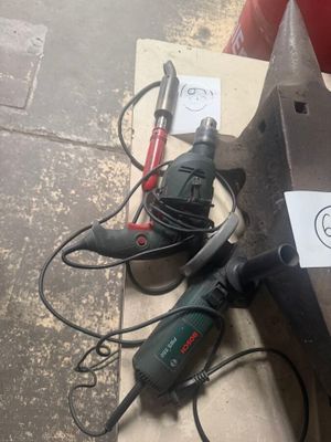 two electric tools on the floor next to a box