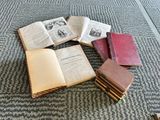 several open books sitting on top of each other on top of a carpet