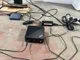 a black box sitting on the floor next to a bunch of wires