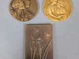 two gold coins with a woman and a man on them