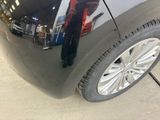 a man that is standing in front of a car
