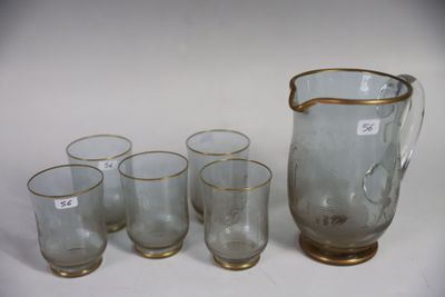 five glasses and a pitcher sitting on a table