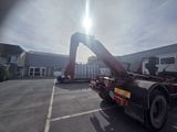 a large red truck with a crane on it ' s back