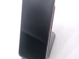 a cell phone that is sitting on top of a stand