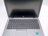 an open laptop computer sitting on top of a white table