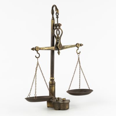 an old brass scale with two scales on it