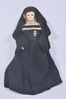 figurine of a woman dressed in black with a star on her head
