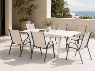 une table et des chaises blanches sur une terrasse avec vue sur l'océan