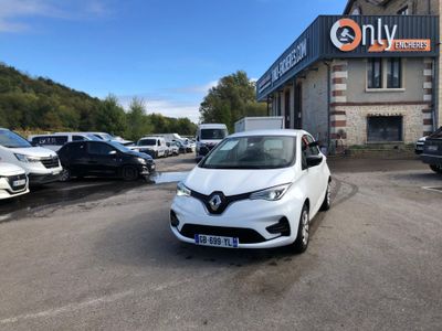 a white car parked in front of a building in a parking lot