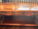 a wooden table with two drawers on top of it