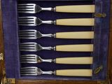 six forks and six knives in a wooden case