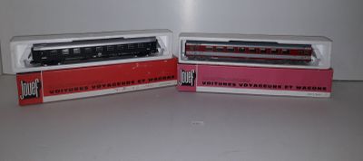 two toy trains sitting side by side on a table