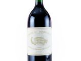 a bottle of red wine sitting on top of a white table