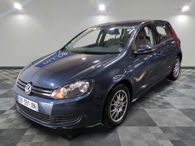 La Volkswagen Golf bleue est garée sur un sol en carrelage à damier.